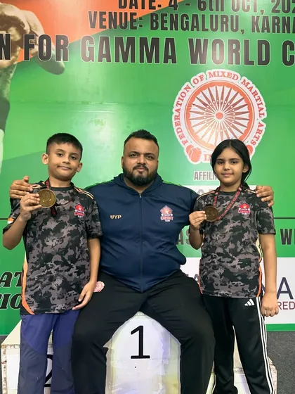 The result of our hard work. Here I am with two of our junior national champions, Shivam and Mishty, after their big win. My greatest pride is seeing these kids start from scratch and rise to the top. We build champions here, and their medals are a testament to our shared journey.