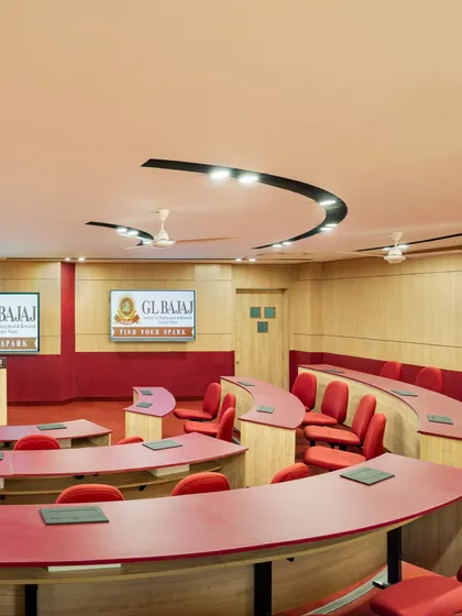 The integration of technology in a GL Bajaj University classroom, with screens and a podium. Our designs are future-ready, accommodating evolving pedagogical needs and interactive learning tools.