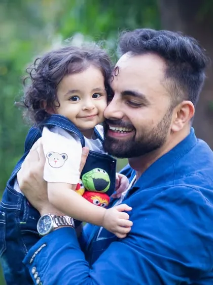 A sweet cuddle between a father and his son. These quiet, tender moments are just as important to capture as the big laughs during a family photoshoot.