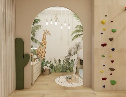Every child deserves a space that nurtures their dreams. This whimsical crèche design features a jungle-themed mural, an arched entryway, and a small climbing wall to spark imagination.