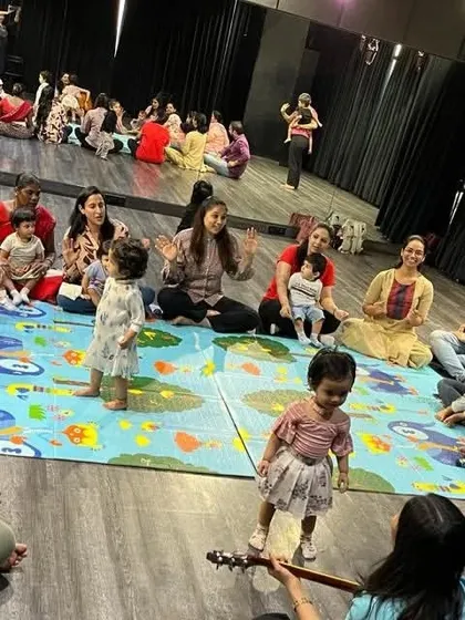 Here I am playing the guitar while the children dance and interact. This shows how we combine live music, movement, and social play in every session.