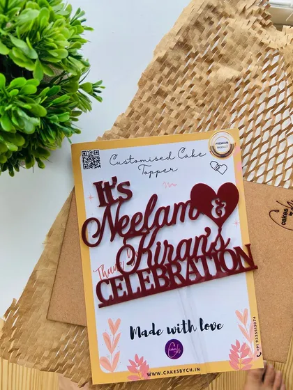 Introducing our new Maroon color! This "It's Neelam & Kiran's Celebration" topper shows off the rich, deep red hue, perfect for a bold and elegant statement.