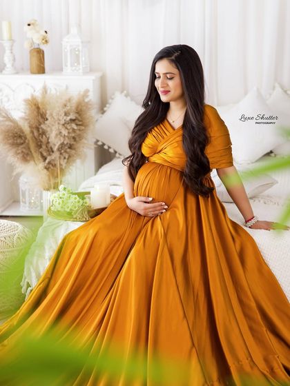 A rich, mustard-yellow gown brings warmth and sunshine to this cozy, indoor bed setup.