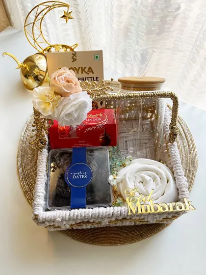 This elegant Eid gift basket combines a glass tumbler, premium dates, Lindt chocolates, and a beautiful crescent moon decor piece.