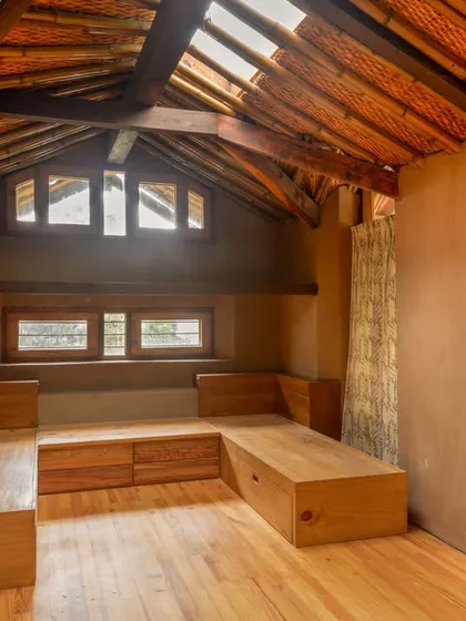 Capturing bedrooms is about conveying a sense of peace and comfort. The skylight in this room was a fantastic feature, bathing the wooden furniture and mud walls in a soft, natural glow. It’s a perfect example of how light can shape the mood of a private sanctuary.