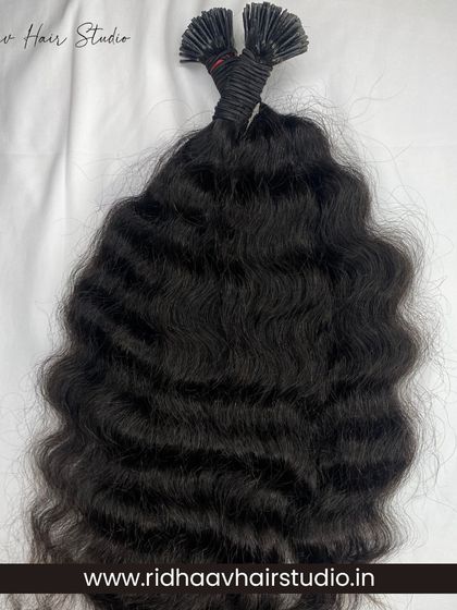 Our I-Tip single-drawn raw curly hair extensions. These offer a more defined, natural curl pattern for those wanting beautiful, textured hair.