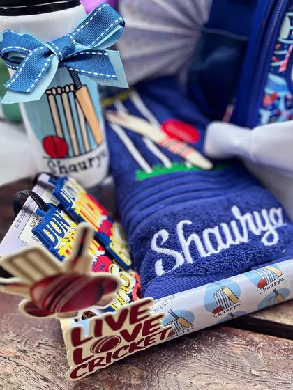 The hamper included a personalized towel and water bottle, all perfectly coordinated with the cricket theme.