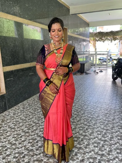 A full-length view of her look, showing how the makeup, hair, and saree come together for a stunning result.
