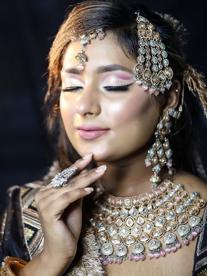 An elegant pose showing the detailed eye makeup with closed eyes.