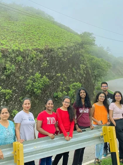 A group of women travelers posing by the roadside on a foggy day. The journey through the hills is as beautiful as the destination.