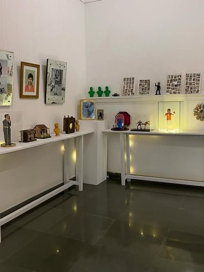 The Dr. Rajkumar shrine from the 'SOUTHERN STARS' exhibition. This collection of memorabilia shows the deep, personal fandom and devotion inspired by the actor.
