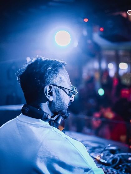 A behind-the-decks shot of Nikhil Chinapa, focused and in control of the music. We provide artists with the best equipment and environment to perform.