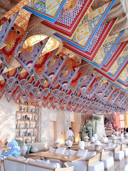 The ceiling of the St. Tropez party, decorated with colorful printed scarves for a bohemian-chic, Mediterranean feel.