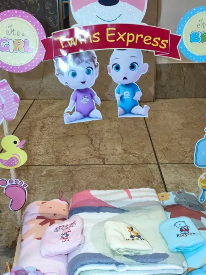 This cart from the 'Twins Express' is filled with soft baby blankets and towels.