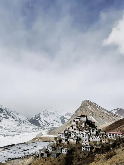A wide-angle view of the Key Monastery against a vast, snow-covered landscape. This image shows the scale and isolation of Spiti in winter, a truly humbling sight.