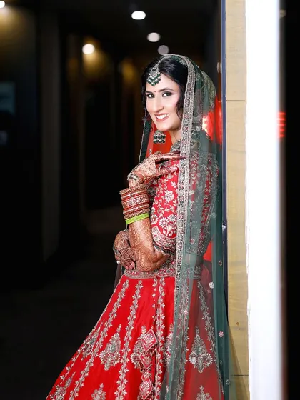 A joyful, over-the-shoulder smile from the bride. These candid portraits capture the happiness and excitement of the wedding day.