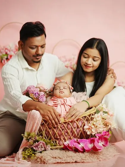 A candid moment during a family session, where the parents look down adoringly at their baby in the basket. These unposed interactions often make for the most cherished photos.