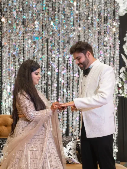 The ring exchange. This photo captures the moment the groom places the ring on the bride's finger, symbolizing their commitment.