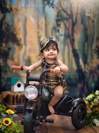 A little musician in the woods. The combination of the tricycle and the forest backdrop creates a sense of adventure and imagination.