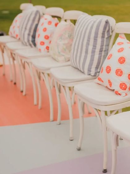 A close-up of the seating at the pastel brunch, with custom-printed cushions featuring citrus and stripe patterns, perfectly complementing the colorful flooring.