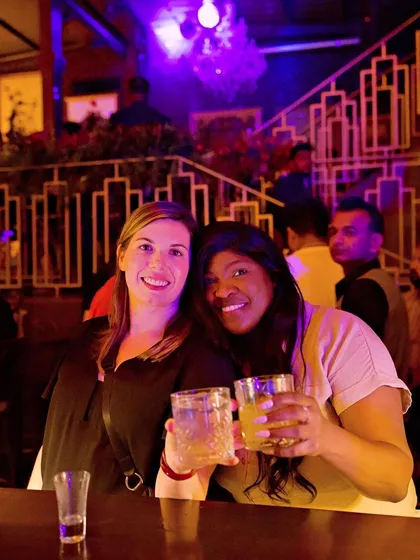 Two friends toasting to a great night out.