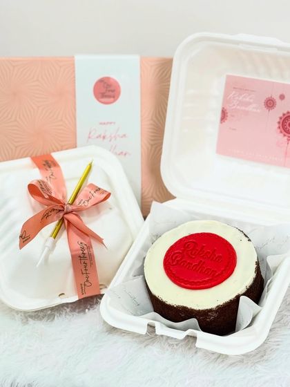 For Rakhi, I offer smaller, personal gifts like this bento cake. It features a rich dark chocolate cake with vanilla buttercream and a "Raksha Bandhan" fondant stamp, making it a simple yet meaningful treat.