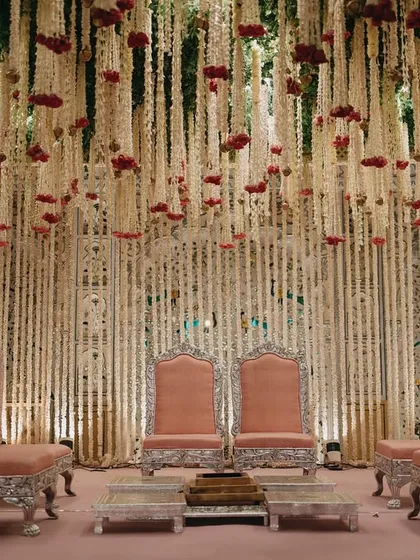 An opulent mandap crafted from thousands of cascading tuberoses and carnations. My in-house floral design team creates these breathtaking structures that serve as a heavenly backdrop for the ceremony.