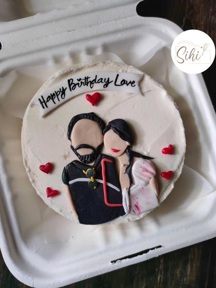 I can turn your favorite photo into an edible portrait. This bento cake features a detailed, hand-painted illustration of a couple, making for a deeply personal and unique celebration cake.