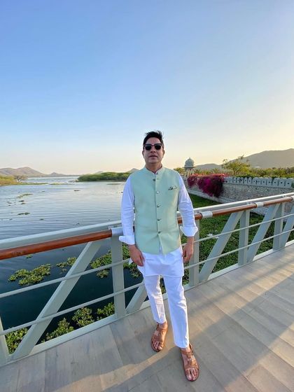A relaxed pose on a bridge over the water in Udaipur. This captures the easygoing yet stylish vibe I bring to daytime events.