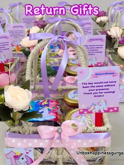 A collection of unicorn-themed return gifts, showcasing the beautiful lavender and pink color palette and personalized tags.