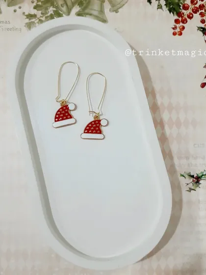 Simple yet festive, these Santa hat hoop earrings are a cute and subtle way to show your holiday spirit.