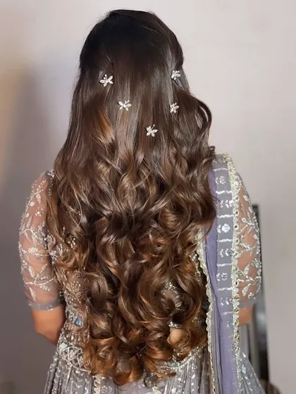 The back view of the Roka hairstyle, with butterfly clips scattered through the curls.