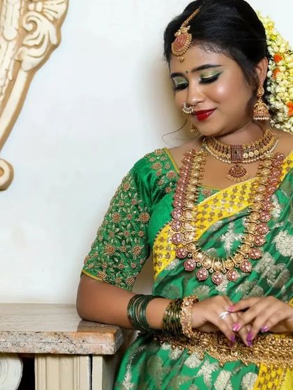 A serene moment captured, showcasing the intricate details of our rental jewellery. The Vaddanam and haram are standout pieces.