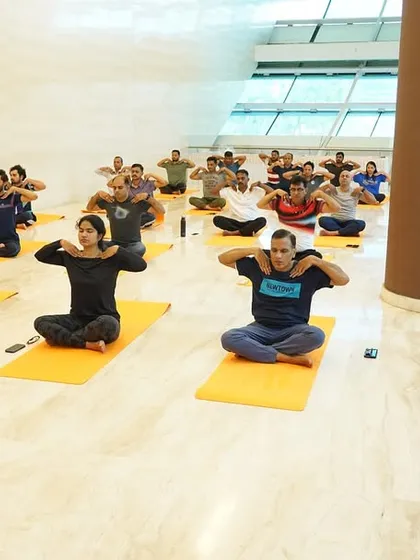 Employees at ONGC in Mumbai learning simple shoulder and neck stretches. These exercises are specifically chosen to counteract the negative effects of prolonged sitting and computer work, promoting better posture and reducing pain.