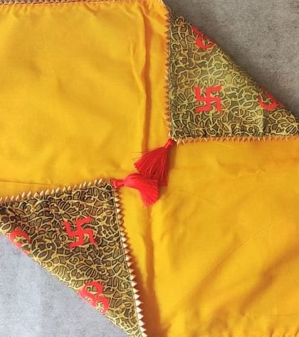 A closer look at the corner detail of my traditional swastik-print antarpat. The combination of printed fabric and a simple yellow base creates a balanced and auspicious design.