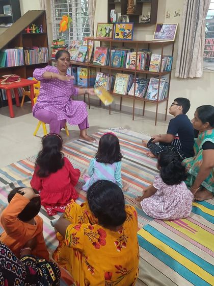 Using a prop to add excitement to the story, the storyteller keeps the children on the edge of their seats.