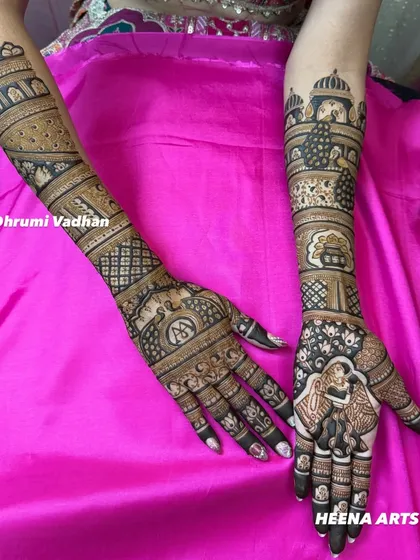 A full view of a personalized bridal mehendi. This design features a portrait of the couple, their monogram, and other meaningful symbols that are special to them.