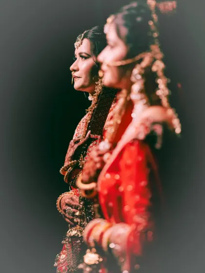 A soft-focus, candid shot of the bride during the ceremony. The focus is on her profile and the traditional attire, creating an atmospheric and emotional image.