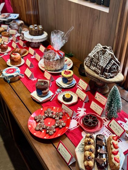 A closer look at our Christmas market stall, showcasing the variety we offer. From gingerbread cookies and eclairs to our large gingerbread house, we have something for every sweet tooth.