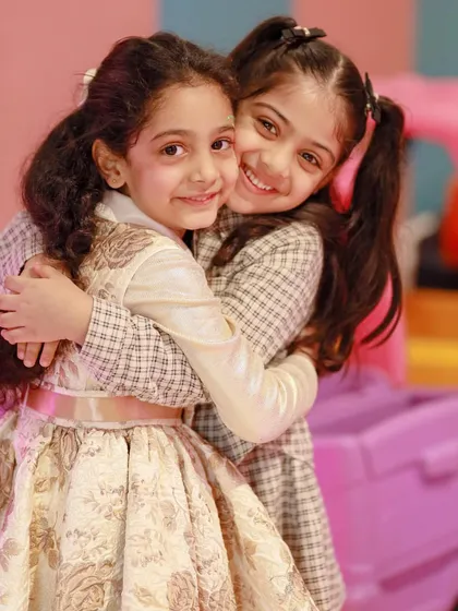 A sweet hug between two friends captures the warmth and joy of our Winter Wonderland themed parties.