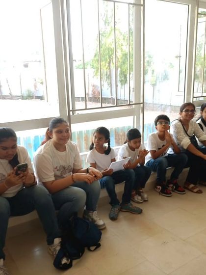 Students waiting in the wings for their turn to perform. This candid shot captures the mix of excitement and nerves that comes with live performance.