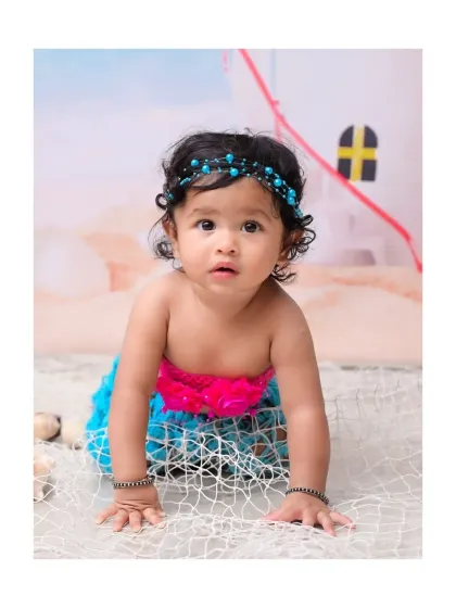 A close-up shot of the baby mermaid crawling towards the camera. This pose is perfect for sitter sessions, capturing that exciting milestone of newfound mobility.