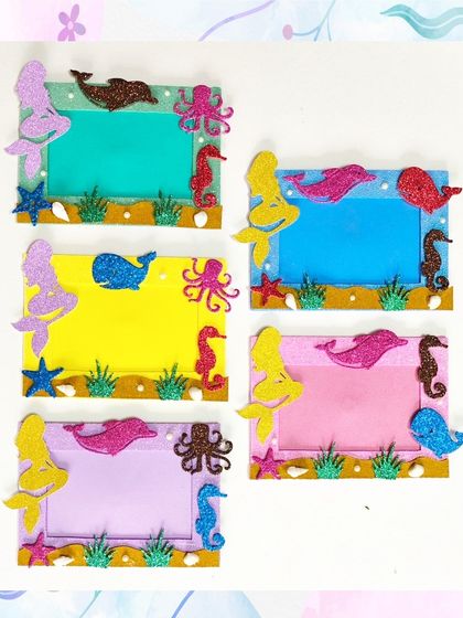 A closer look at the different color combinations for the handmade mermaid-themed magnetic photo frames. Each one is decorated with glittery sea creatures.