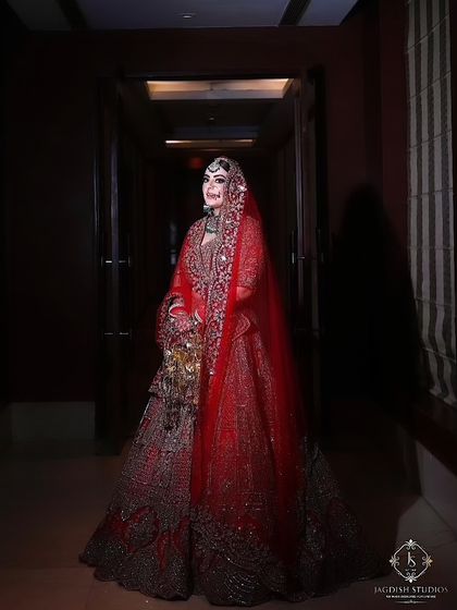 This full-length shot shows how the entire bridal look comes together. The makeup is the final touch that harmonizes the outfit, jewelry, and the bride's natural beauty.