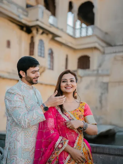 A candid moment of affection, capturing a genuine smile as the groom gently brushes his bride's hair back. These are the unscripted moments we love to capture.