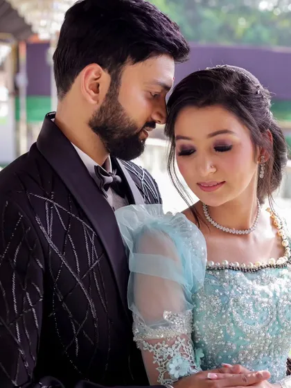 An intimate close-up capturing the tender emotions of an engagement shoot. The soft lighting highlights the intricate details of the bride's gown and the couple's gentle connection.