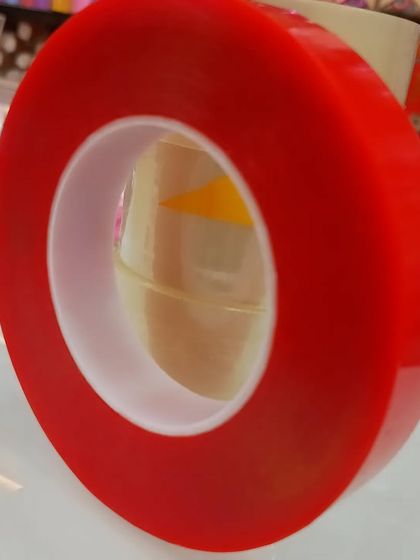 A roll of red, heavy-duty double-sided tape. This is perfect for more demanding applications where a stronger hold is needed for your decorations.