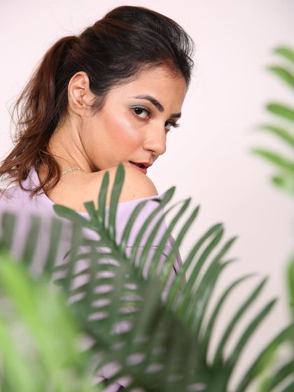 An over-the-shoulder glance captured in the studio, creating a sense of intrigue and allure.