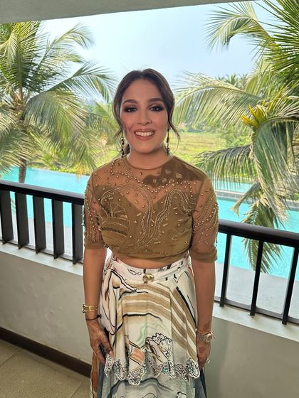 The client looking chic and ready for a carnival party, her textured low ponytail providing a stylish yet comfortable option.