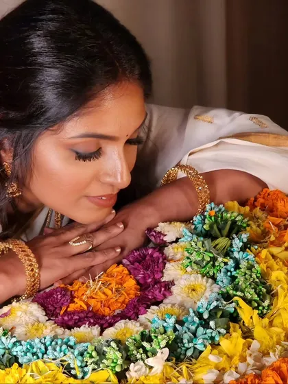 Celebrating the vibrant festival of Onam. This shot captures the beauty of the Pookalam (floral carpet) and the traditional Kerala saree.